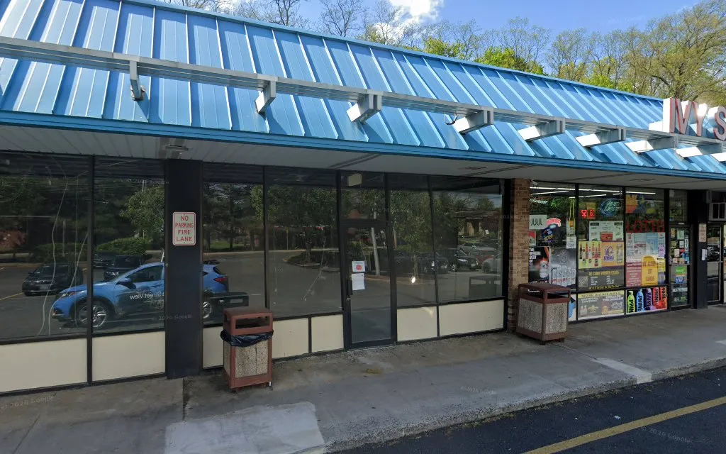 The storefront row with the blue metal awning on Thiells Mt Ivy Road