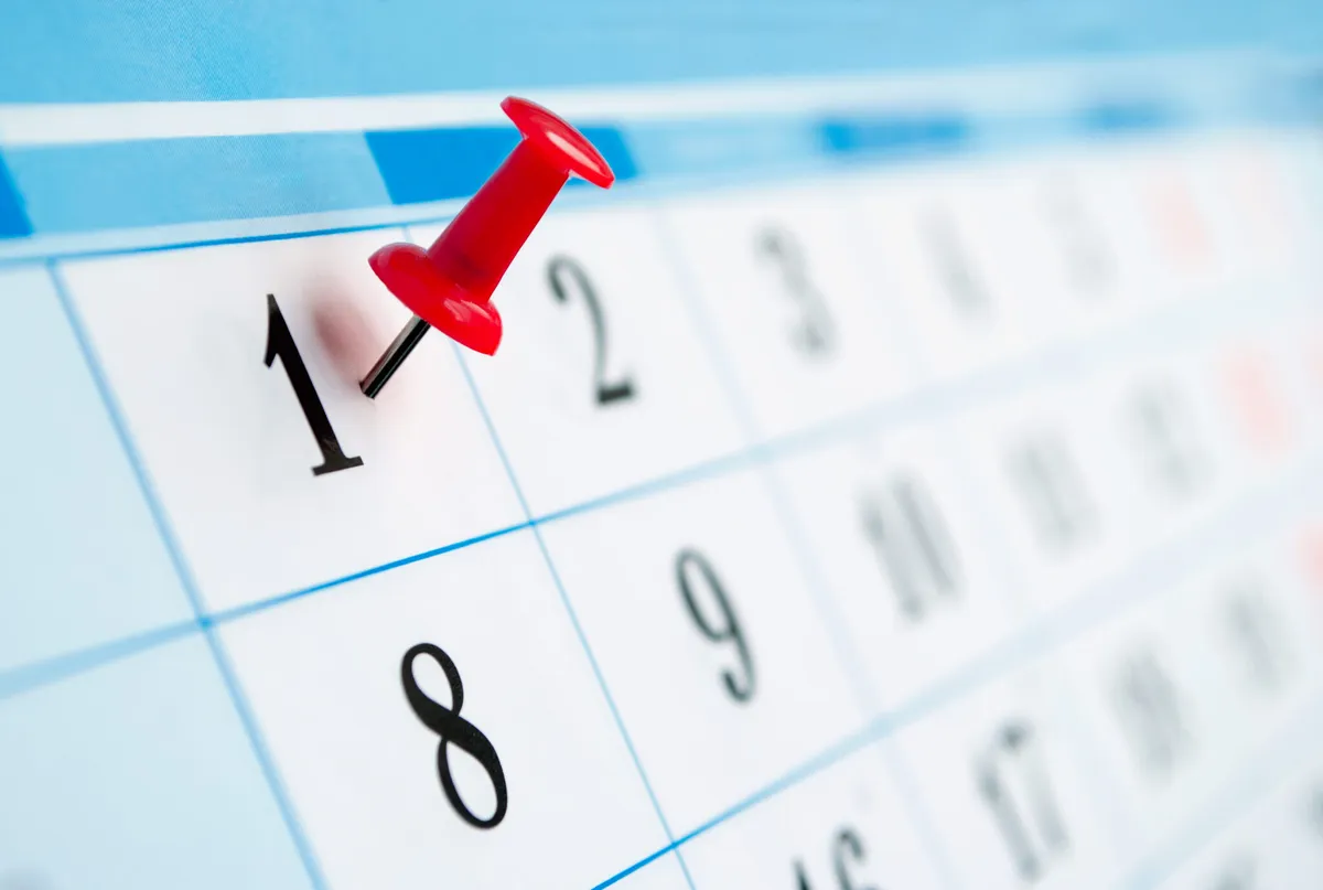 A calendar with a red pin in the first of the month